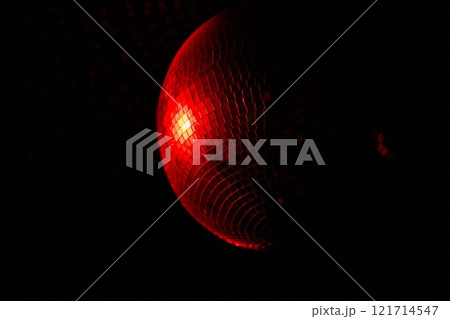 A Disco Ball Shining Red Light, Creating an Energetic Atmosphere Perfect for Celebrating A Disco Ball Shining Red Light, Creating an Energetic Atmosphere Perfect for Celebrating 121714547