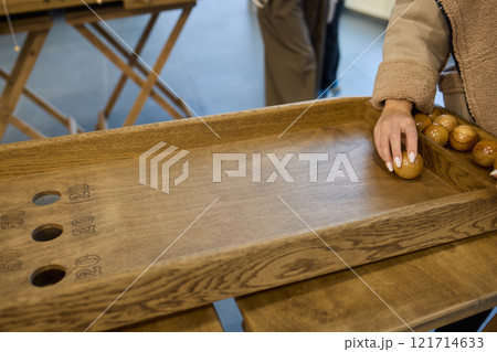 Enjoy a Classic Shuffleboard Game with a beautifully crafted Wooden Board and Puck for fun 121714633