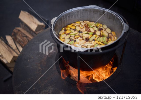 The Glow of Embers and Flames in a Steel Cooking Pot Outdoors Under the Starry Sky The Glow of Embers and Flames in a Steel Cooking Pot Outdoors Under the Starry Sky 121715055