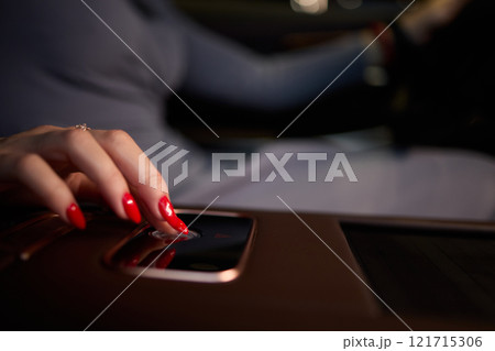 To start a car, the engine is initiated by turning a key in the ignition switch with the hand To start a car, the engine is initiated by turning a key in the ignition switch with the hand 121715306