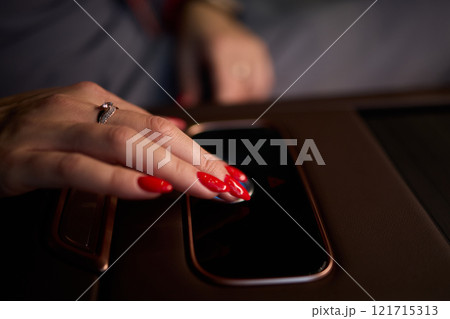 To start a car, the engine is initiated by turning a key in the ignition switch with the hand 121715313