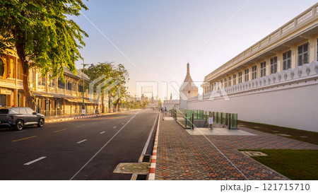 Na Phra Lan Road in front of The Bangkok Grand Palace featuring white walls and traditional architecture under a sunrise sky. 121715710