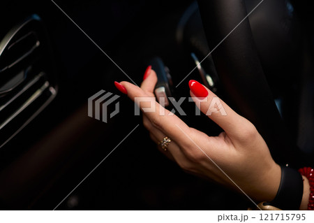 To start a car, the engine is initiated by turning a key in the ignition switch with the hand To start a car, the engine is initiated by turning a key in the ignition switch with the hand 121715795