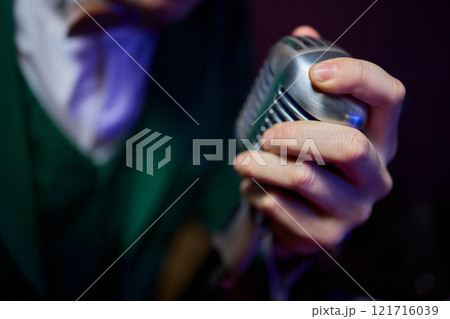The Iconic Classic Microphone Hand Gesture, Perfectly Captured in a Dynamic and Vibrant Setting The Iconic Classic Microphone Hand Gesture, Perfectly Captured in a Dynamic and Vibrant Setting 121716039