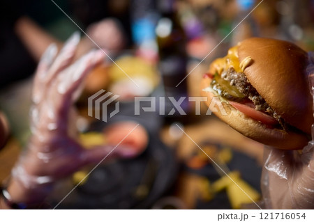 Savor a delicious gourmet burger paired with crispy fries for an unforgettable dining experience Savor a delicious gourmet burger paired with crispy fries for an unforgettable dining experience 121716054