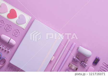 Pastel purple stationery flat lay with notepad, clips, writing supplies, stickers, stapler. Space for text. Pastel purple stationery flat lay with notepad, clips, writing supplies, stickers, stapler. Space for text. 121716071