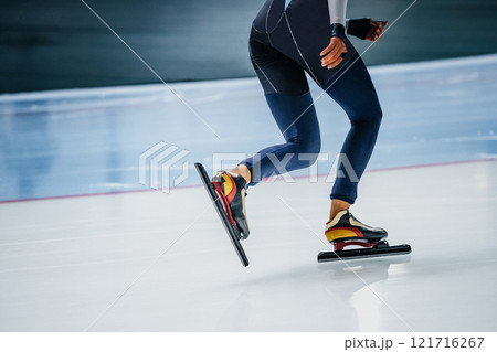 legs female speed skater in dark blue skin suit and skates 121716267