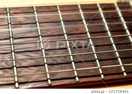 Guitar with wooden brown neck and strings. Guitar with wooden brown neck and strings. 121716461