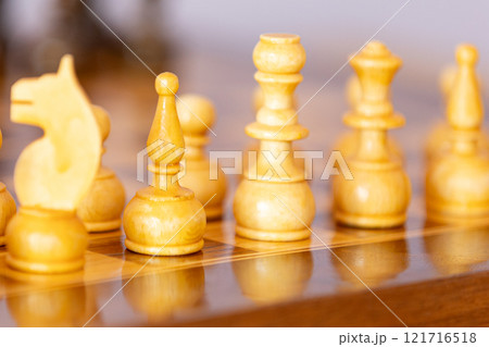 Wooden white chess pieces on the chessboard 121716518