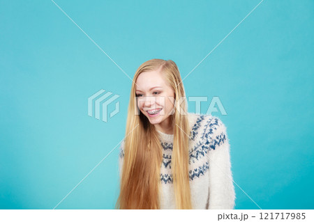 Happy woman showing her braces on teeth 121717985