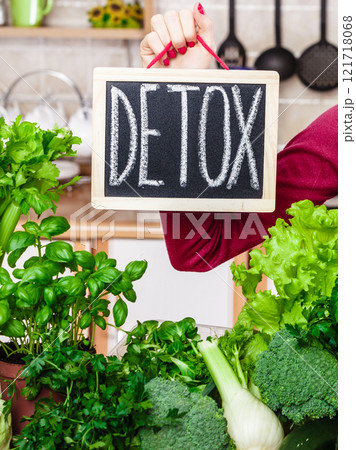 Woman having green diet vegetables, detox sign 121718068