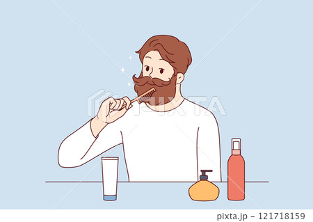 Brutal man takes care of beard and mustache, uses comb to create beautiful image Brutal man takes care of beard and mustache, uses comb to create beautiful image 121718159