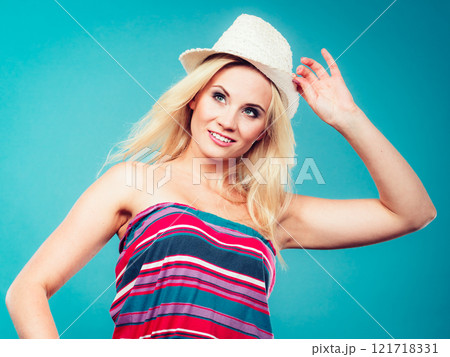 Blonde woman wearing colorful striped strapless shirt 121718331