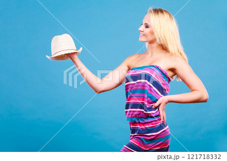 Blonde woman wearing short colorful striped dress Blonde woman wearing short colorful striped dress 121718332
