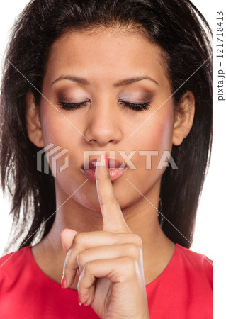 Woman with finger on lips showing silence gesture. Woman with finger on lips showing silence gesture. 121718413