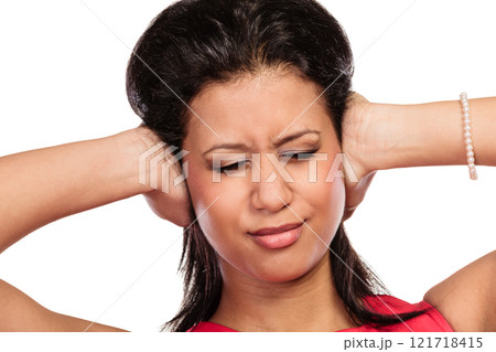 Mixed race woman closing ears with hands. 121718415