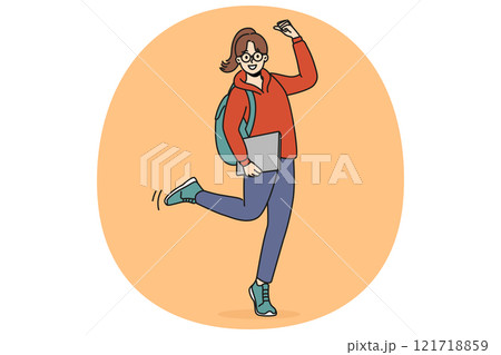 Cheerful teen girl makes victory gesture and holds books in hands and celebrating entering college 121718859