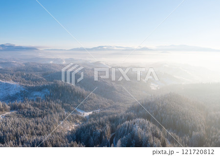 Mountain valley. Scene from drone. Forest covered in snow. Natural winter landscape from air. Mountain valley. Scene from drone. Forest covered in snow. Natural winter landscape from air. 121720812
