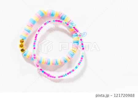 Little girl's charming bracelets adorned with clay and sea beads. Little girl's charming bracelets adorned with clay and sea beads. 121720988