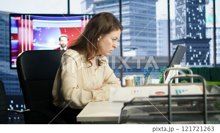 Woman in a powerful executive role oversees budget analysis for investment strategy, showcasing commitment to financial success and sustainable growth in the corporate sector. Camera A. Woman in a powerful executive role oversees budget analysis for investment strategy, showcasing commitment to financial success and sustainable growth in the corporate sector. Camera A. 121721263