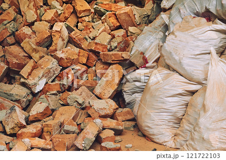 Broken trash in bags. A pile of red brick fragments. Cleaning and repair Broken trash in bags. A pile of red brick fragments. Cleaning and repair 121722103