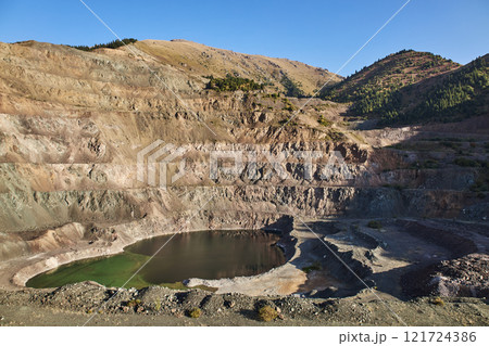 Old open mining pit with pond in mountain Old open mining pit with pond in mountain 121724386