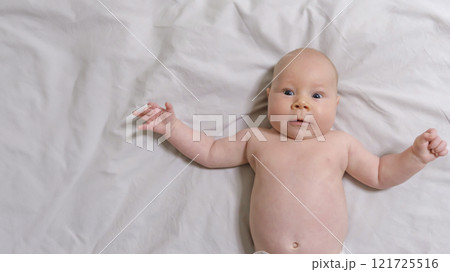 Joyful Two-Month-Old Baby Boy on a Light Background. Selective Focus Joyful Two-Month-Old Baby Boy on a Light Background. Selective Focus 121725516