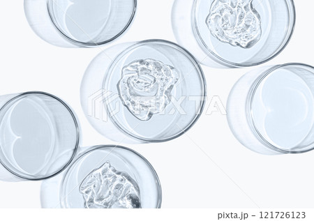 Skin serum or face wash gel in a Petri dish. For cosmetic procedures. White background Skin serum or face wash gel in a Petri dish. For cosmetic procedures. White background 121726123