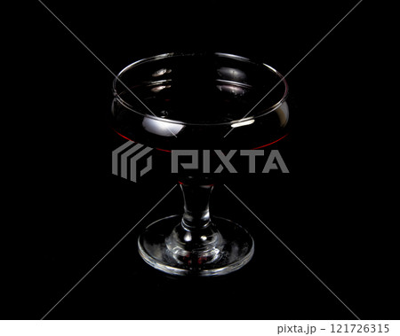 Red wine in glass on black background with copy space Red wine in glass on black background with copy space 121726315