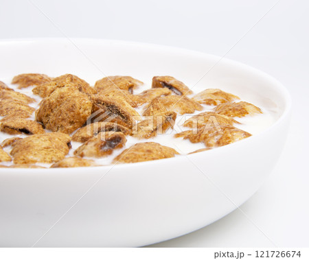 Crispy pads chocolate pillows with milk in dish isolated on the white background 121726674