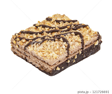 Tasty wafer with dropped nuts and chocolate isolated on the white background Tasty wafer with dropped nuts and chocolate isolated on the white background 121726691