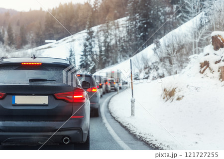 Scenic view many cars stuck row mountain alpine forest road traffic jam cold winter day at Europe mountain resort. Automobile accident vehicle rush hour collapse. Vacation transport seasonal stuck. 121727255