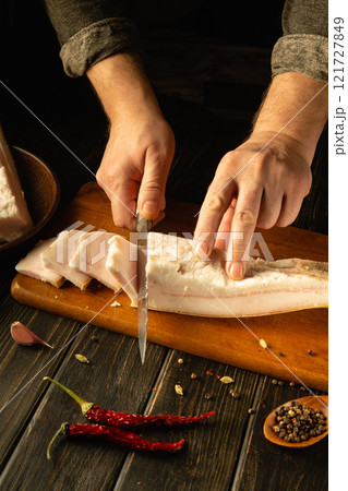 Mastering the art of culinary preparation with fresh fish and spices in a rustic kitchen. Ukrainian national food 121727849