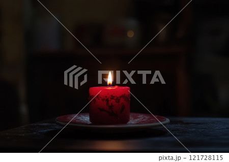 One Red Candle on a festive background. Advent, Christmas, holiday and traditions 121728115