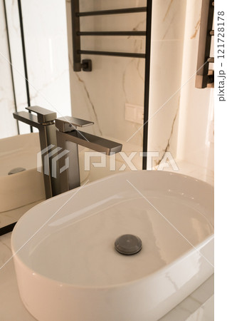 Chrome water faucet and white pedestal sink in bathroom . Stylish bathroom Chrome water faucet and white pedestal sink in bathroom . Stylish bathroom 121728178
