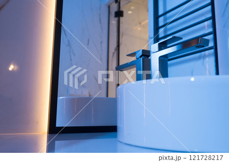Chrome water faucet and white pedestal sink in bathroom . Stylish bathroom Chrome water faucet and white pedestal sink in bathroom . Stylish bathroom 121728217