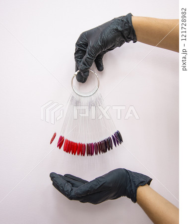 Multicolor different palette gel varnishes examples for manicure in hand selective focus Multicolor different palette gel varnishes examples for manicure in hand selective focus 121728982