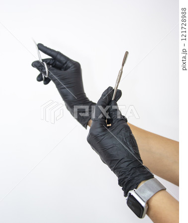 Beauty salon nails content black gloves on woman hand 121728988