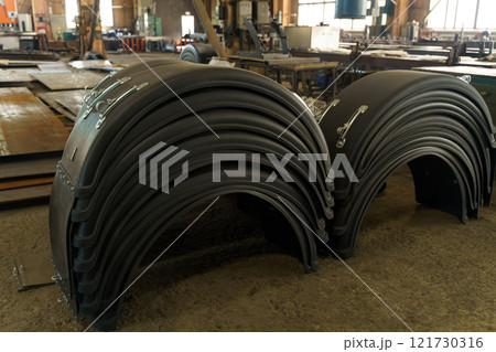 Industrial workshop displaying stacked rubber components Industrial workshop displaying stacked rubber components 121730316