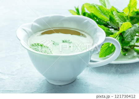 Mint tea. A cup of peppermint tea with fresh mint leaves 121730412