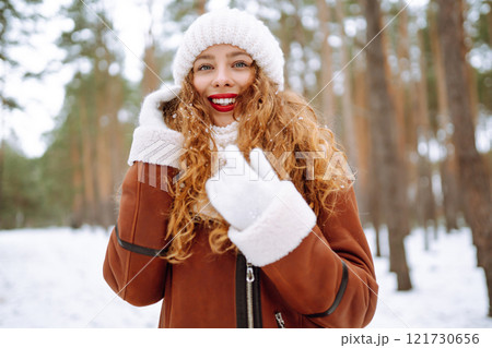 Happy young woman in the winter forest. Christmas, winter holidays concept. Happy young woman in the winter forest. Christmas, winter holidays concept. 121730656