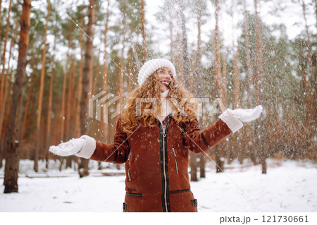 Happy young woman in the winter forest. Christmas, winter holidays concept. 121730661