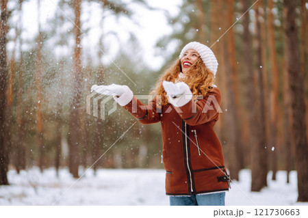 Happy young woman in the winter forest. Christmas, winter holidays concept. 121730663