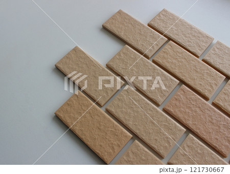 Facing tiles imitating the surface of bricks on a white surface angle view stock photo Facing tiles imitating the surface of bricks on a white surface angle view stock photo 121730667