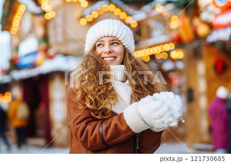 Happy woman posing at a festive street market. Holiday concept, relaxation. 121730685