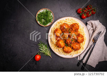 Meatballs with spices and sauce in a plate 121730702