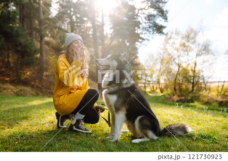 Happy female posing outdoors with her dog. Concept of friendship, vacation, walk. 121730923