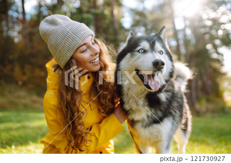 Happy female posing outdoors with her dog. Concept of friendship, vacation, walk. Happy female posing outdoors with her dog. Concept of friendship, vacation, walk. 121730927