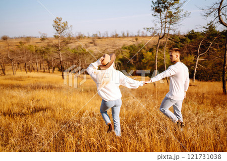 Young couple having fun walking and hugging n the park. Autumn weather. Relaxation, youth. Young couple having fun walking and hugging n the park. Autumn weather. Relaxation, youth. 121731038