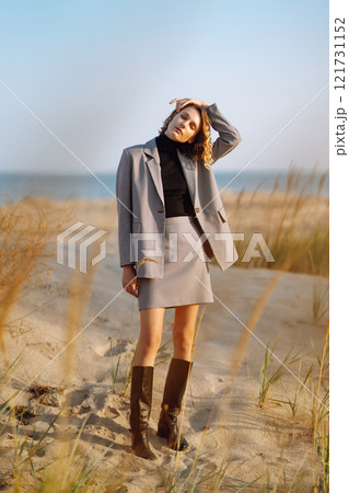 Fashion Model posing near the sea. Young woman resting in nature. People, lifestyle, relaxation. Fashion Model posing near the sea. Young woman resting in nature. People, lifestyle, relaxation. 121731152